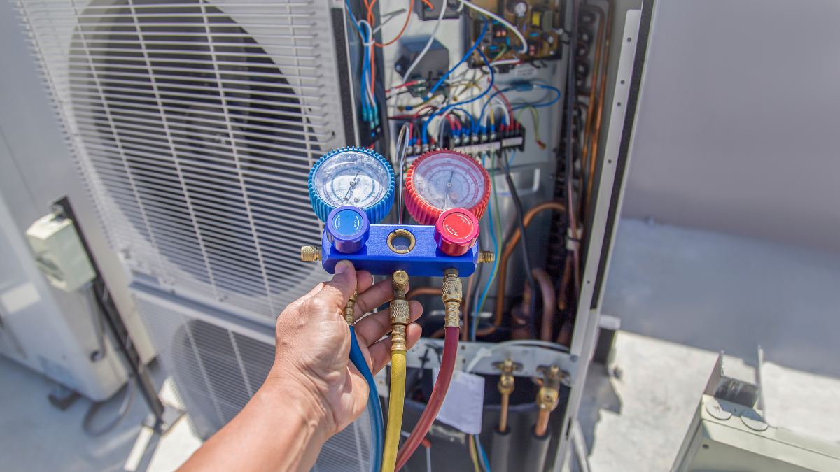 1 HVAC technician testing a thermostat